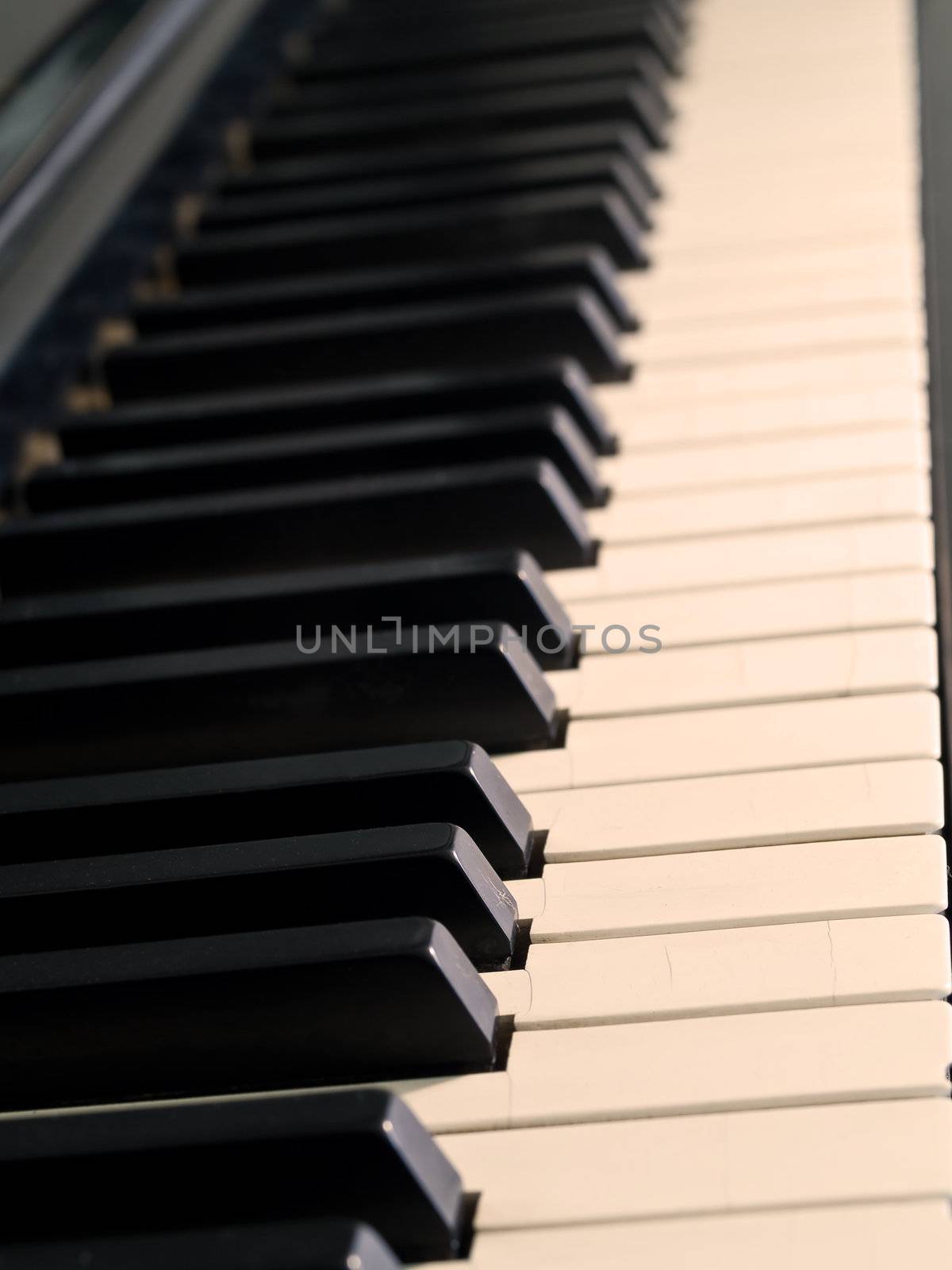 Piano keys of a very well loved and often played piano in Sepia