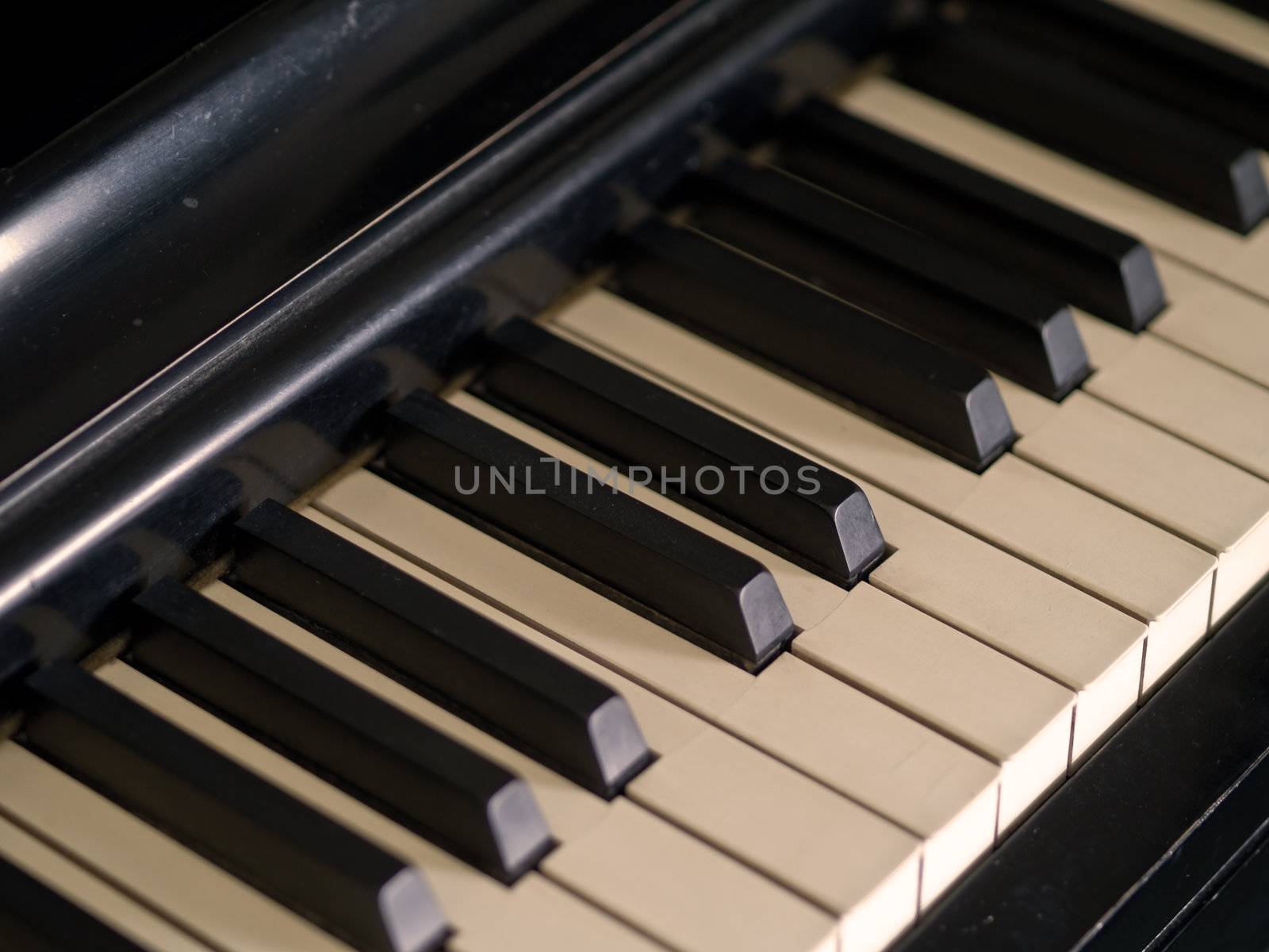 Piano keys of a very well loved and often played piano in Sepia