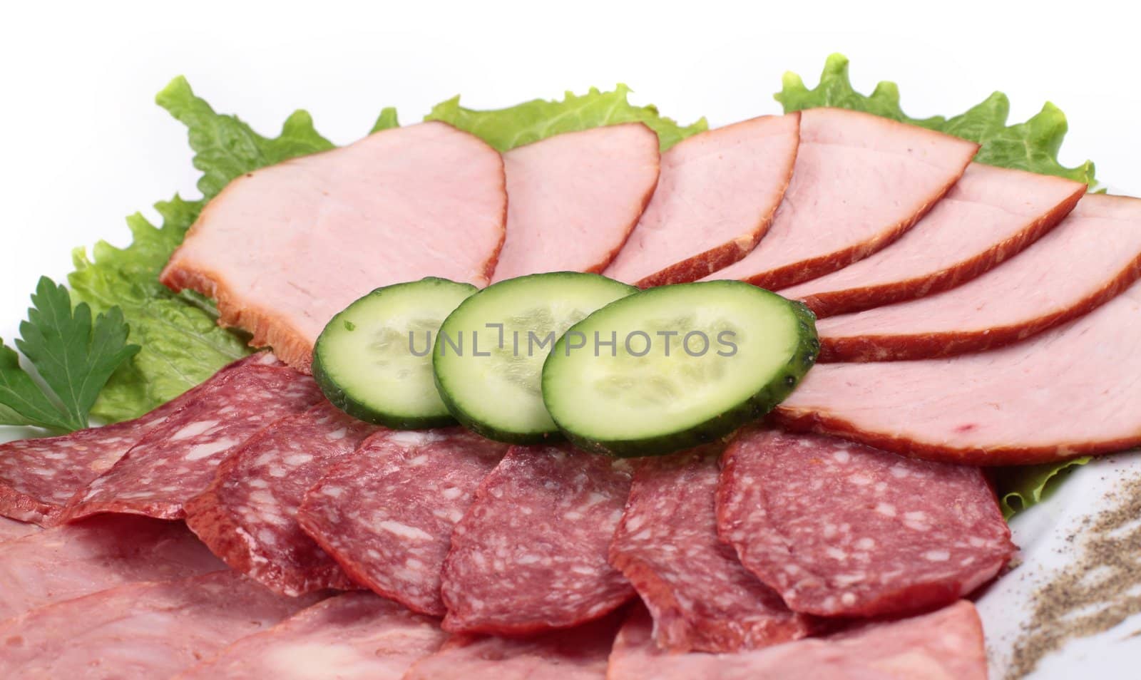 various sliced sausages with vegetables close up