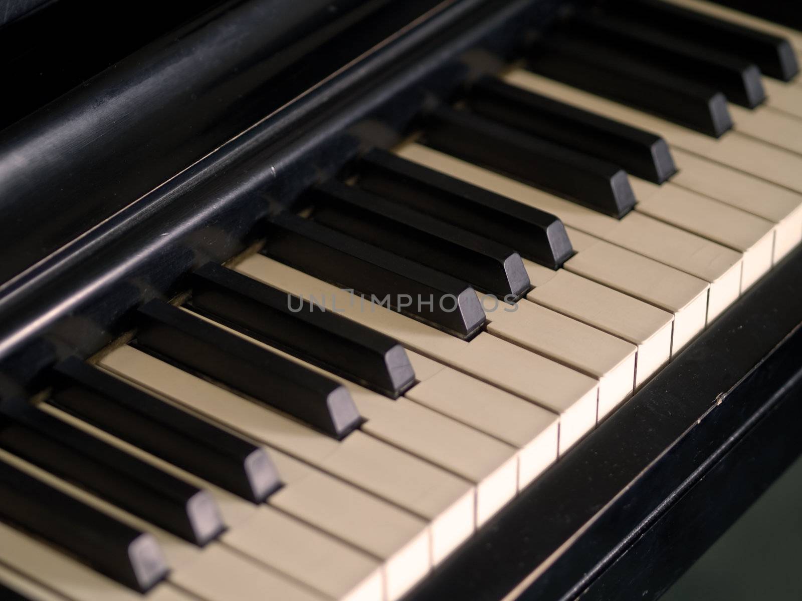 Piano keys of a very well loved and often played piano in Sepia