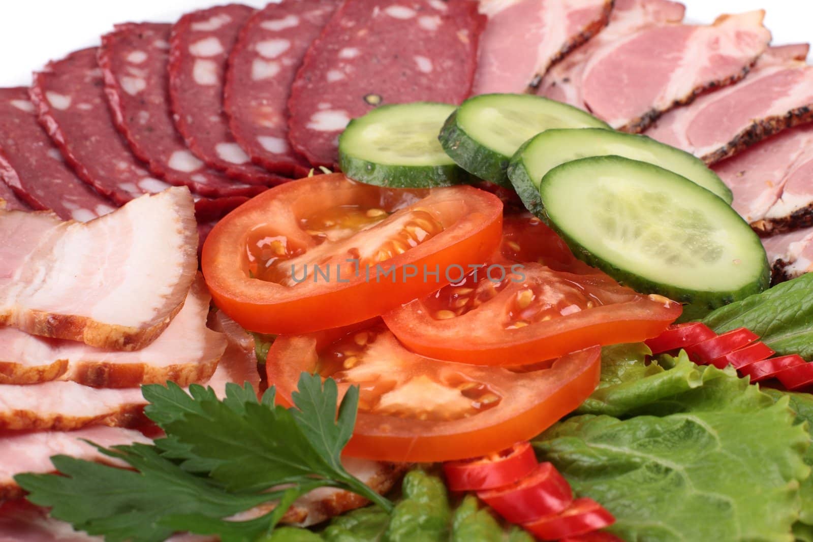 various sliced sausages with vegetables close up