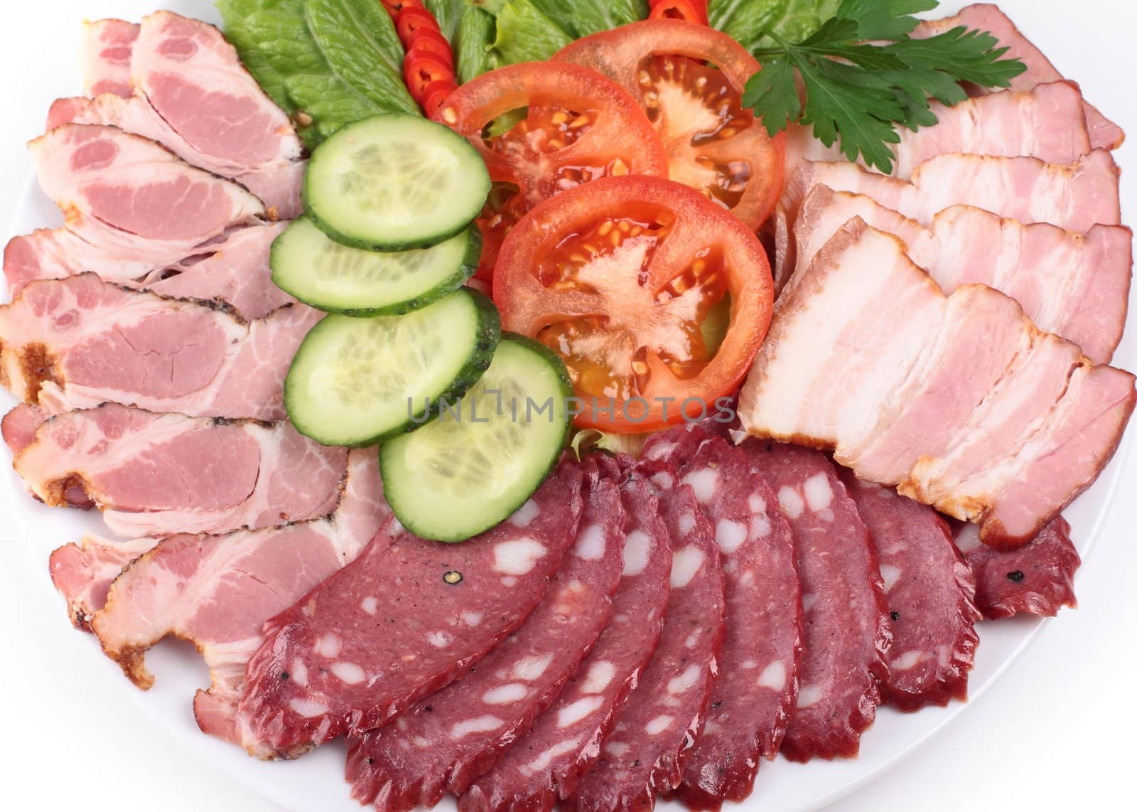 various sliced sausages with vegetables close up