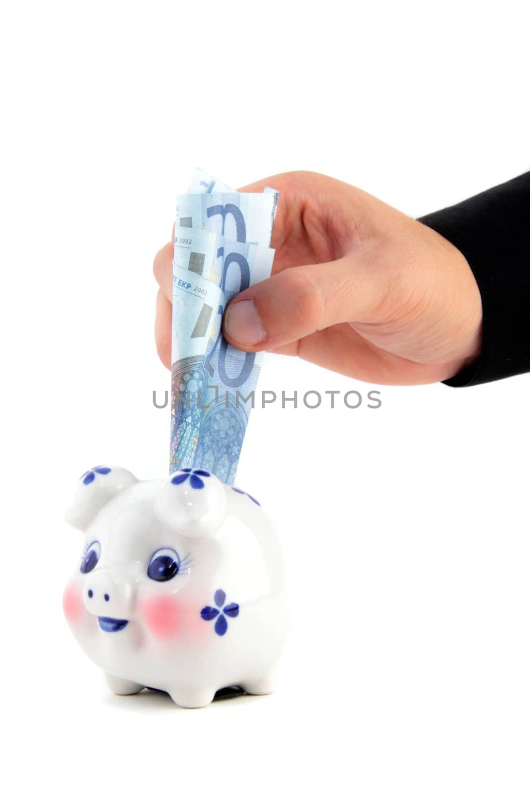 hand put euro in piggy-bank isolated on white