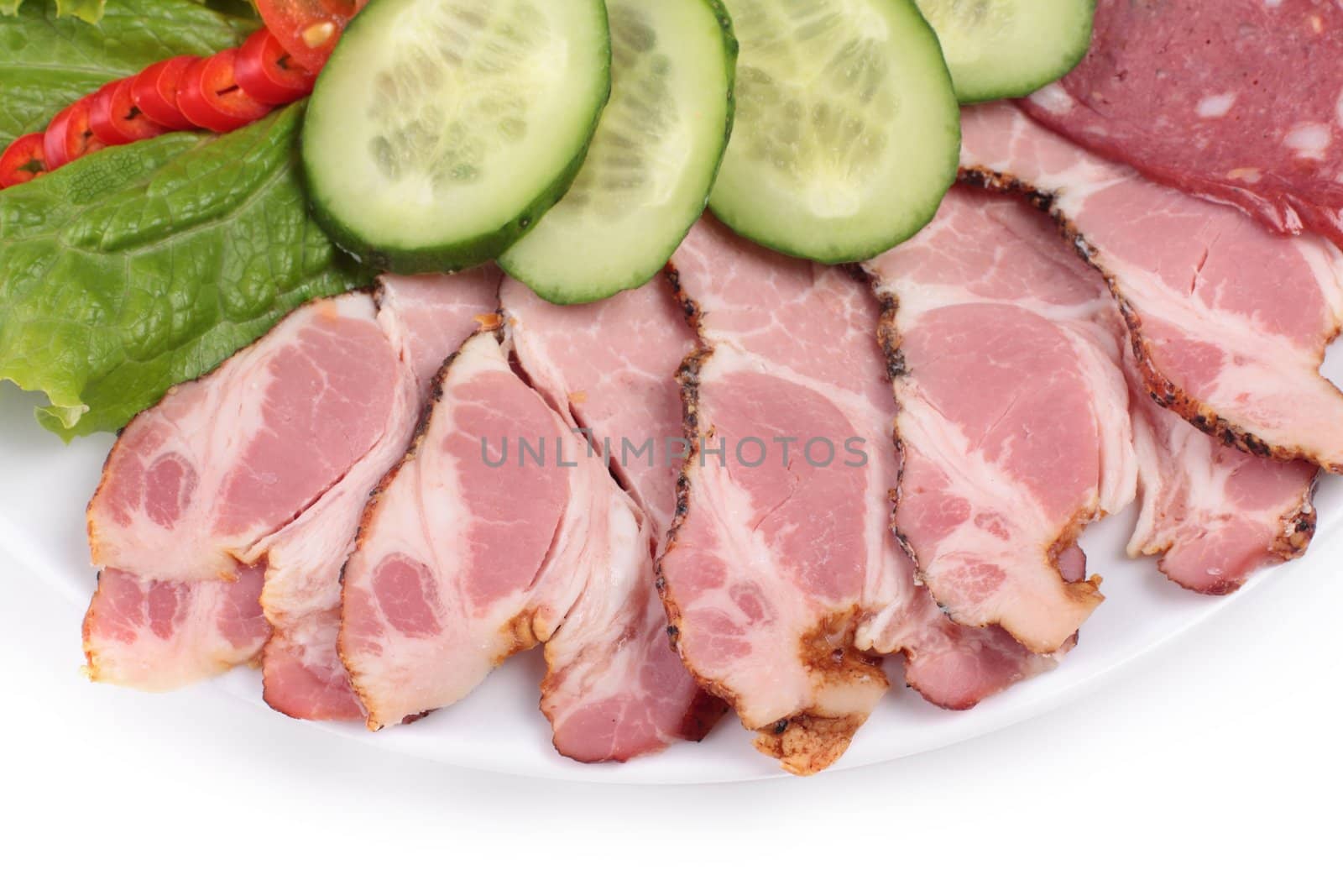 various sliced sausages with vegetables close up