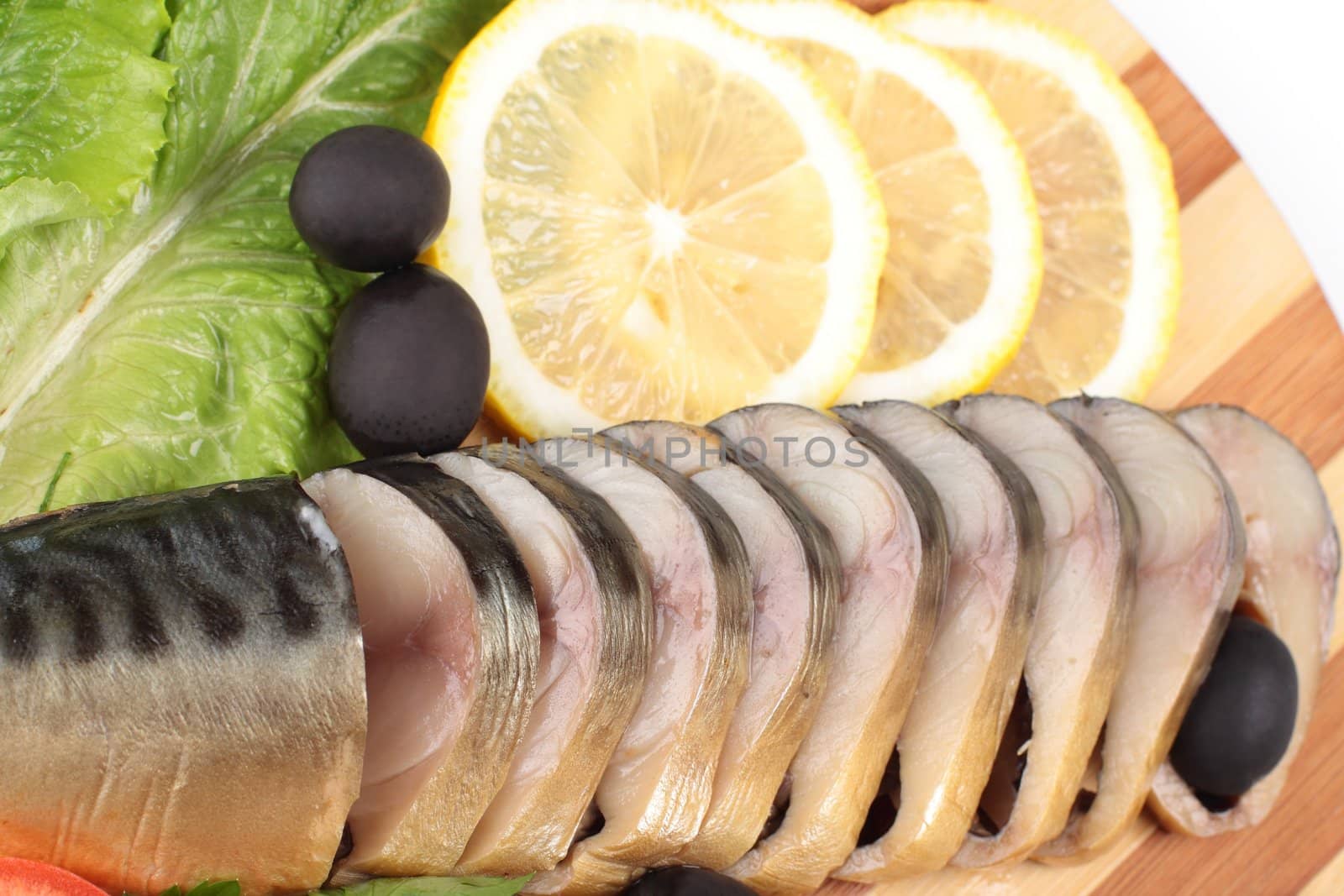 sliced herring on wooden plate close up