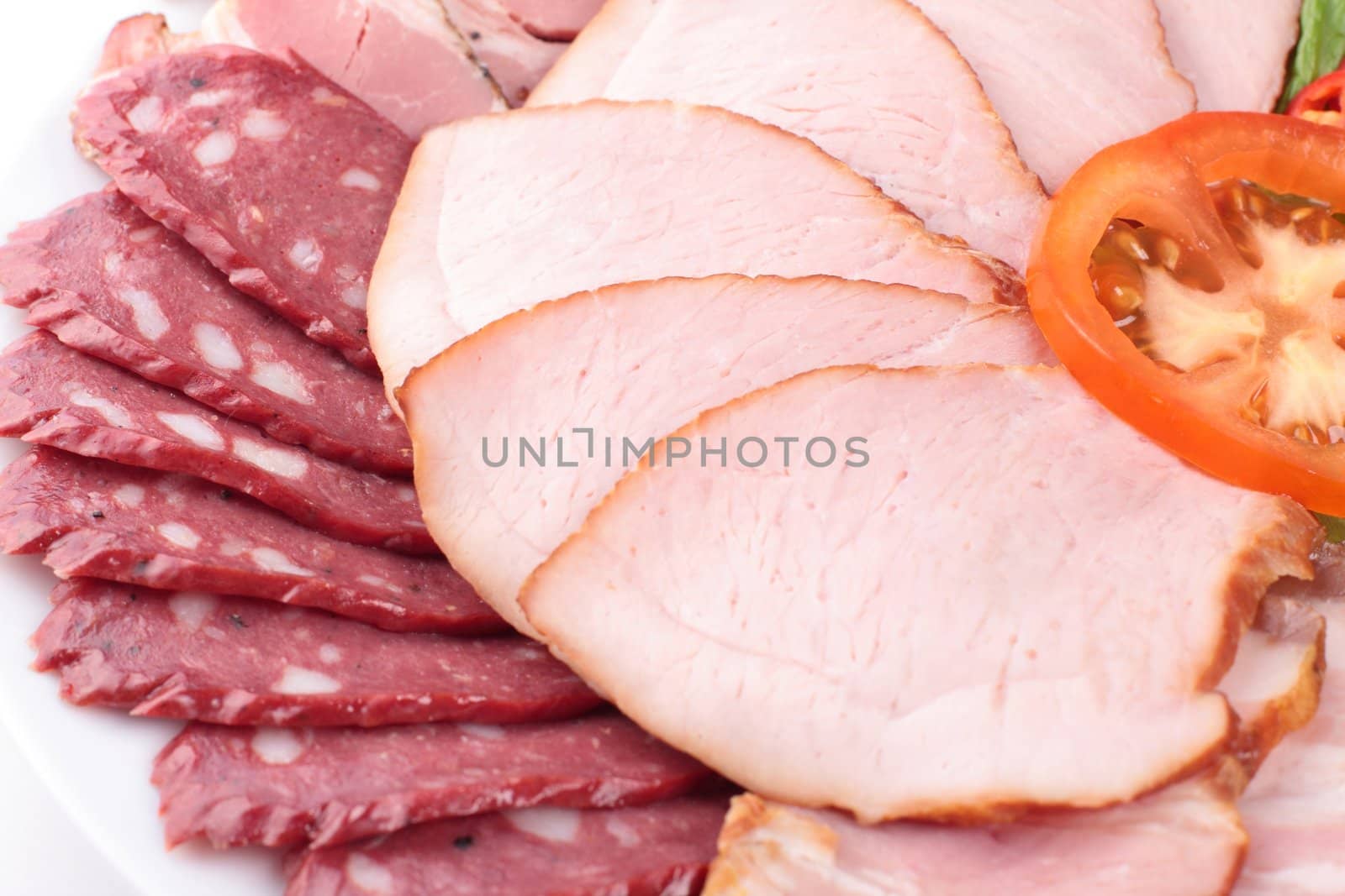 various sliced sausages with vegetables lose up