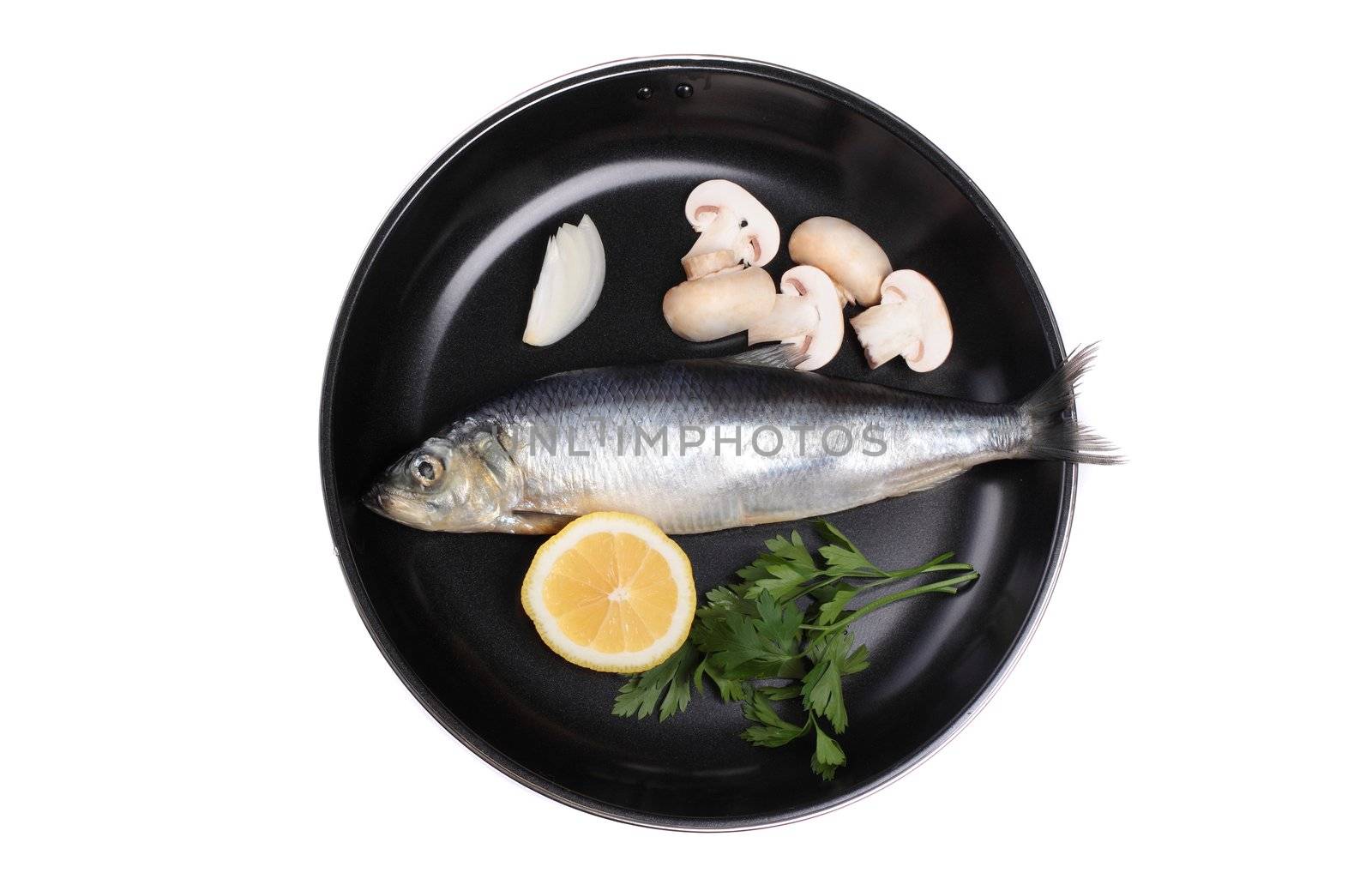 fish in pan with vegetables isolated on white