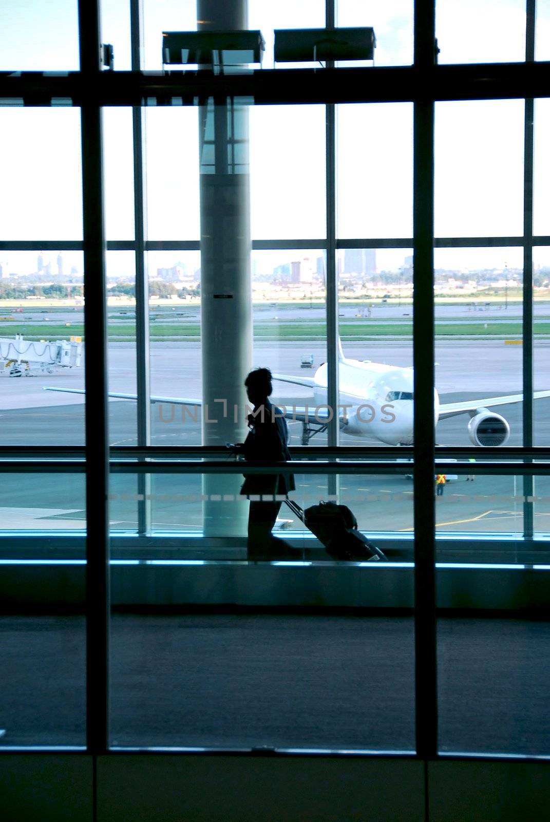 Woman walking in the airport with luggage