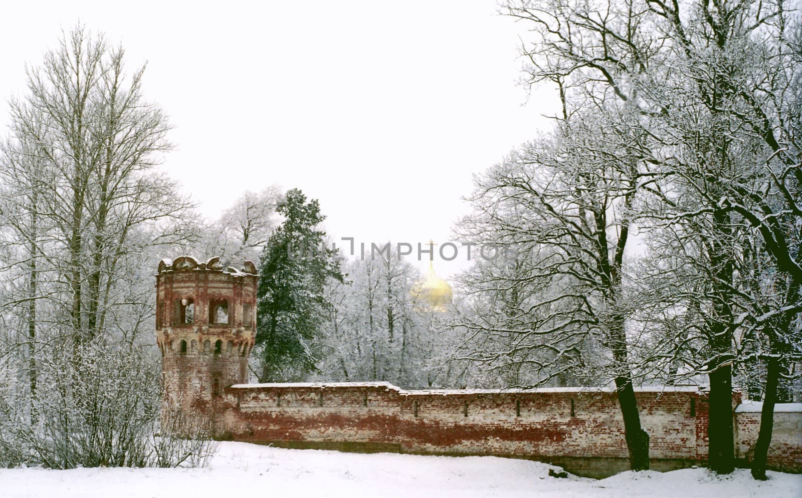 Ancient red brick walls and a cupola of church on background