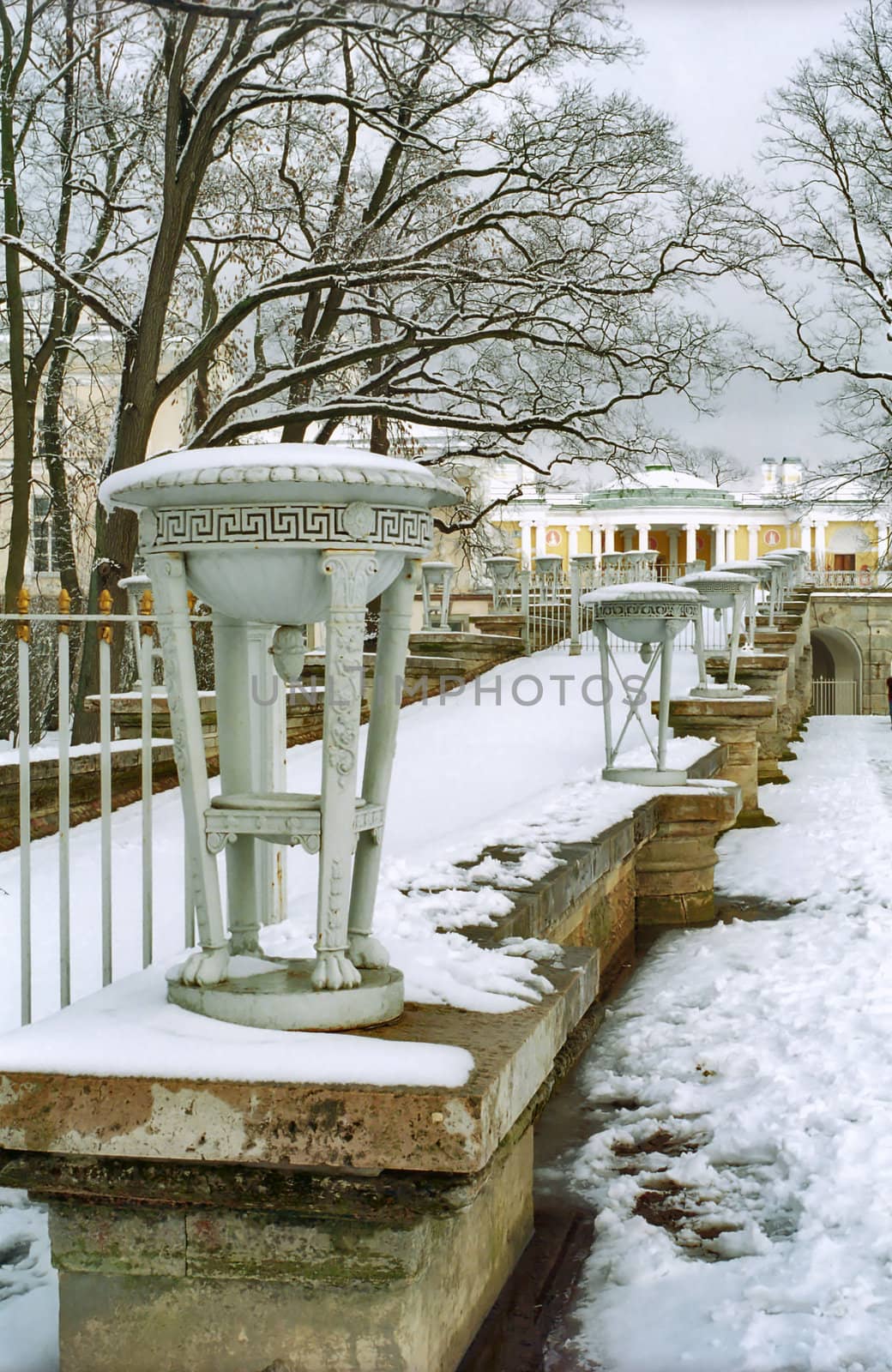Decor of old building in winter with tripod vase in front