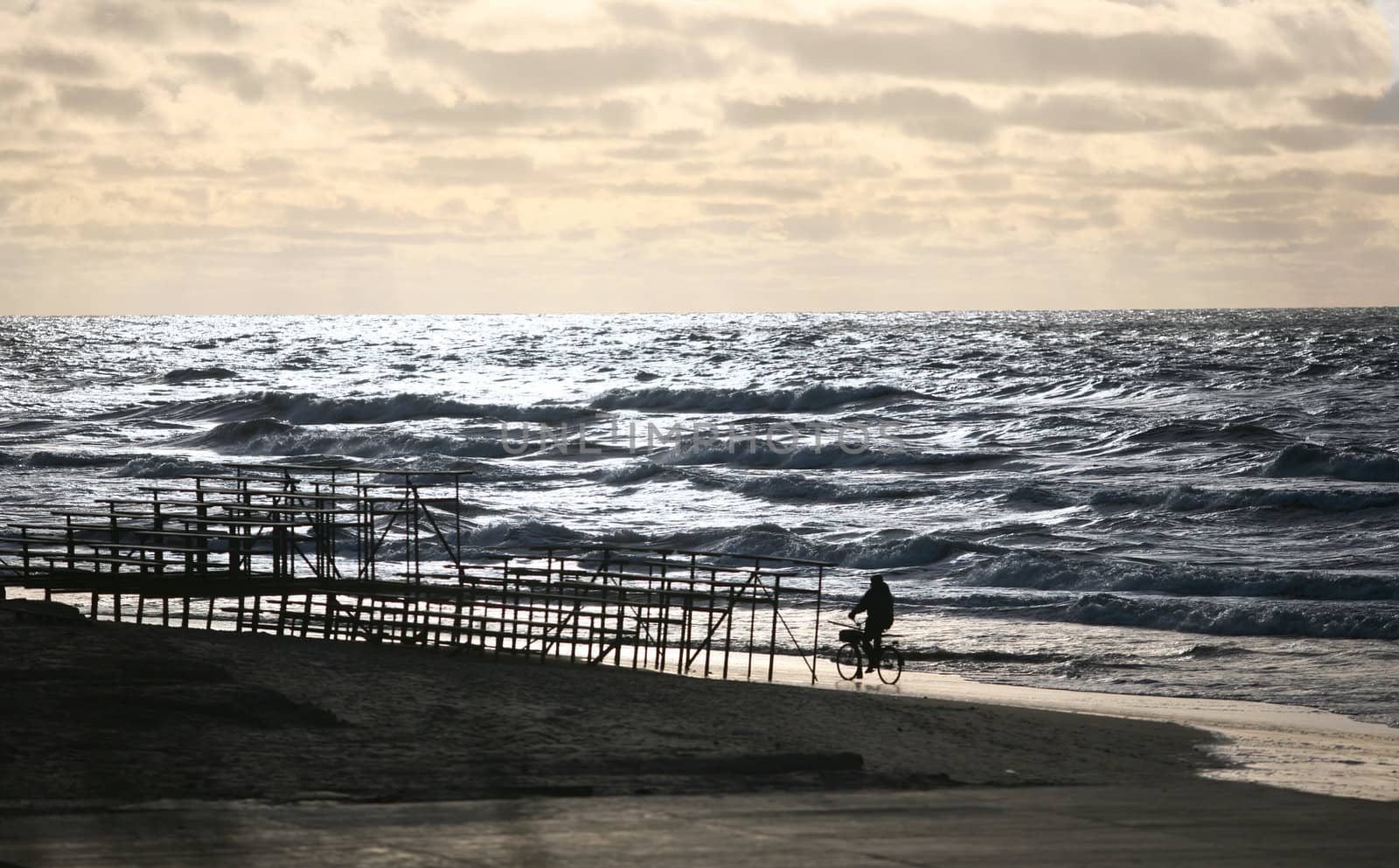 The man on a bicycle goes on seacoast