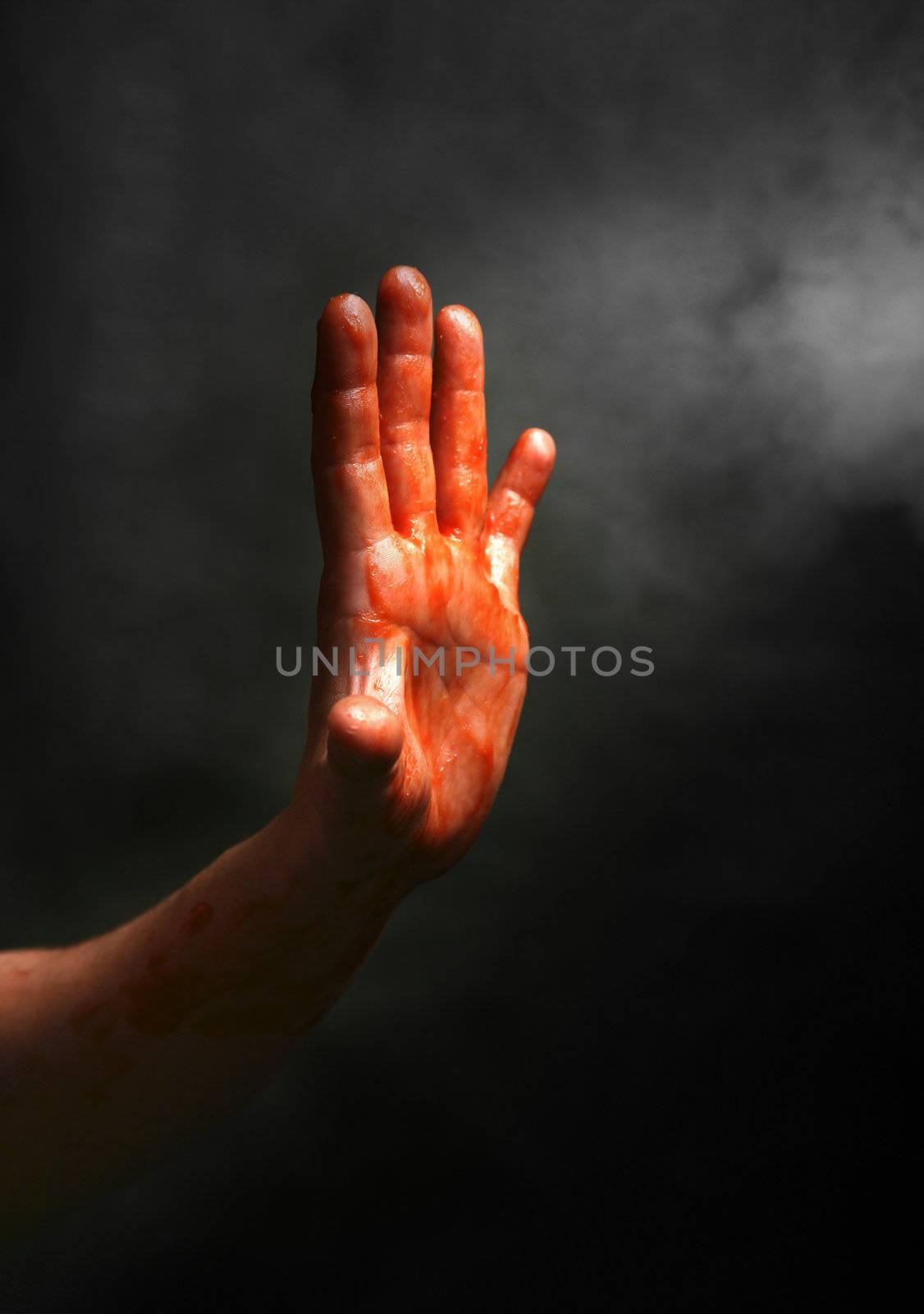 Man's hand on a black background with a smoke