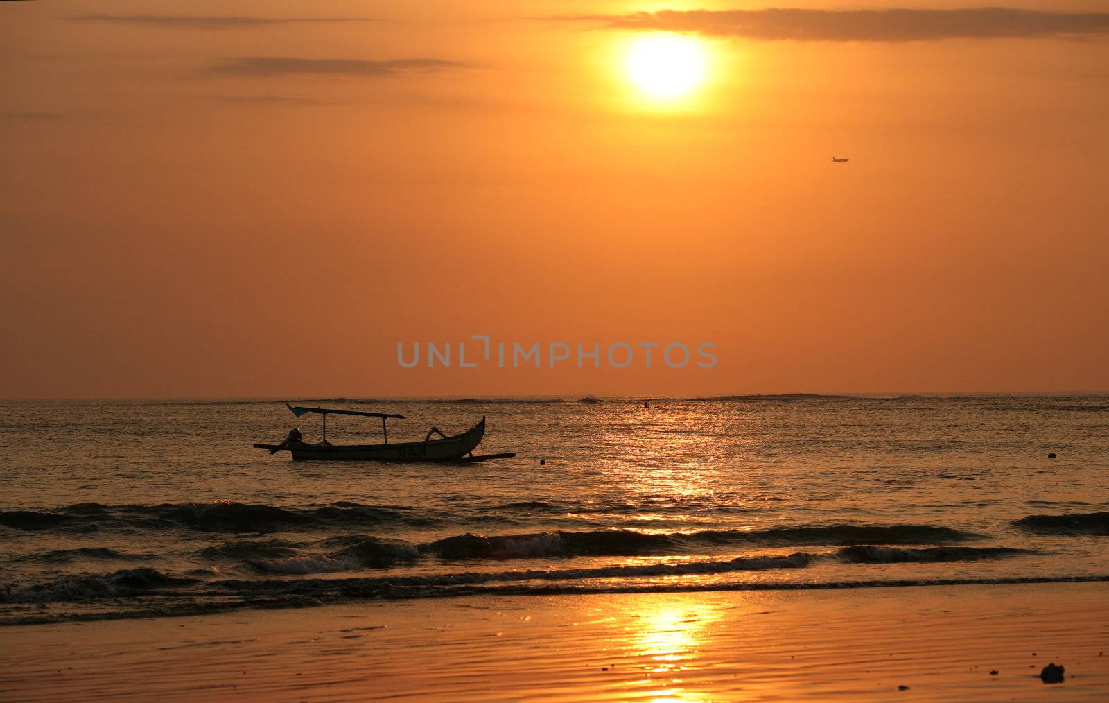 Drifting boat on a sunset. Coast of the Indian ocean. Bali