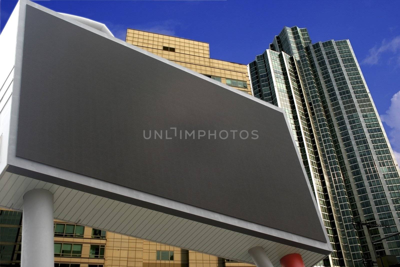 Blank Billboard with buildings  - ready for commercial use.