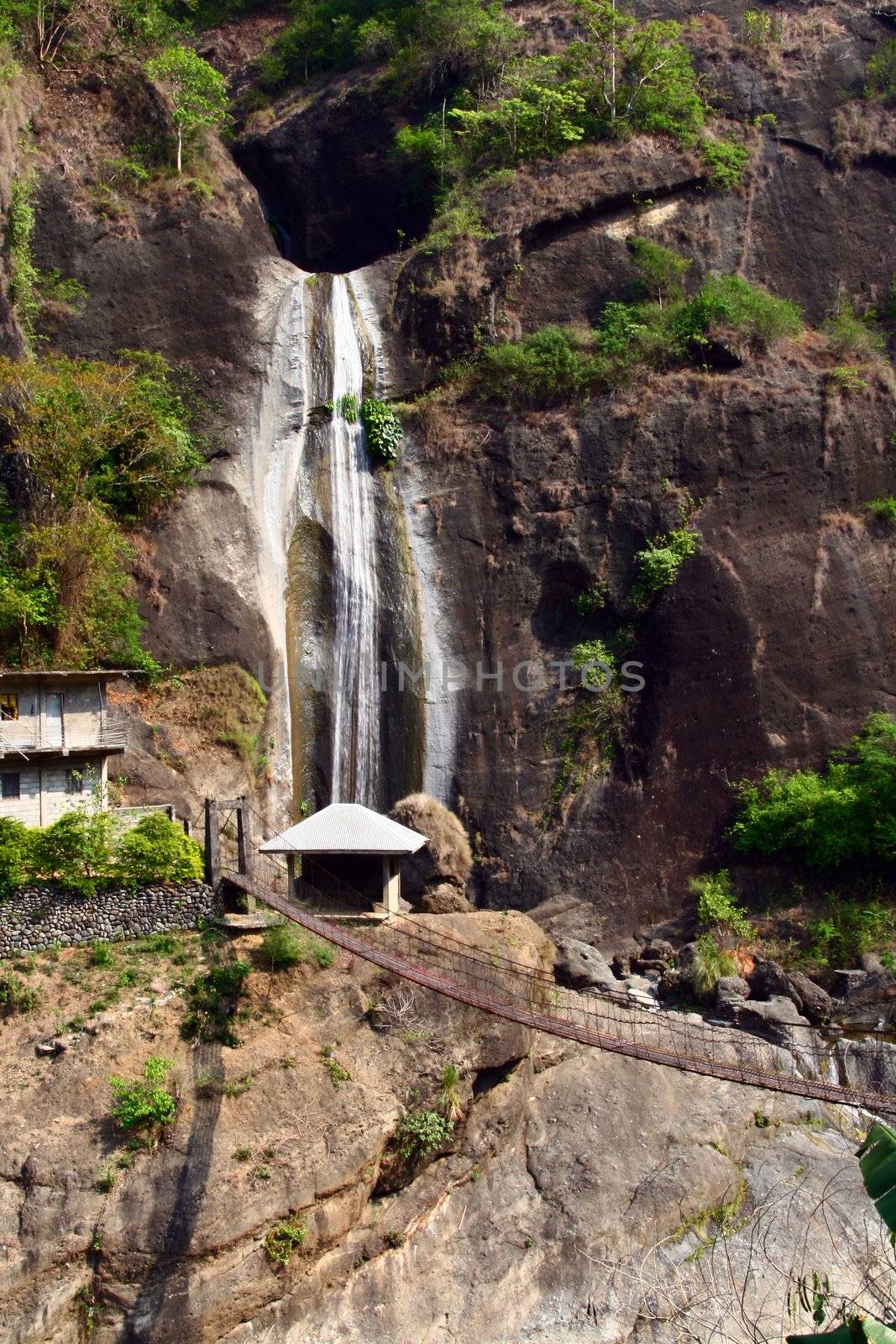 overlooking waterfalls with hanging bridge beneath
