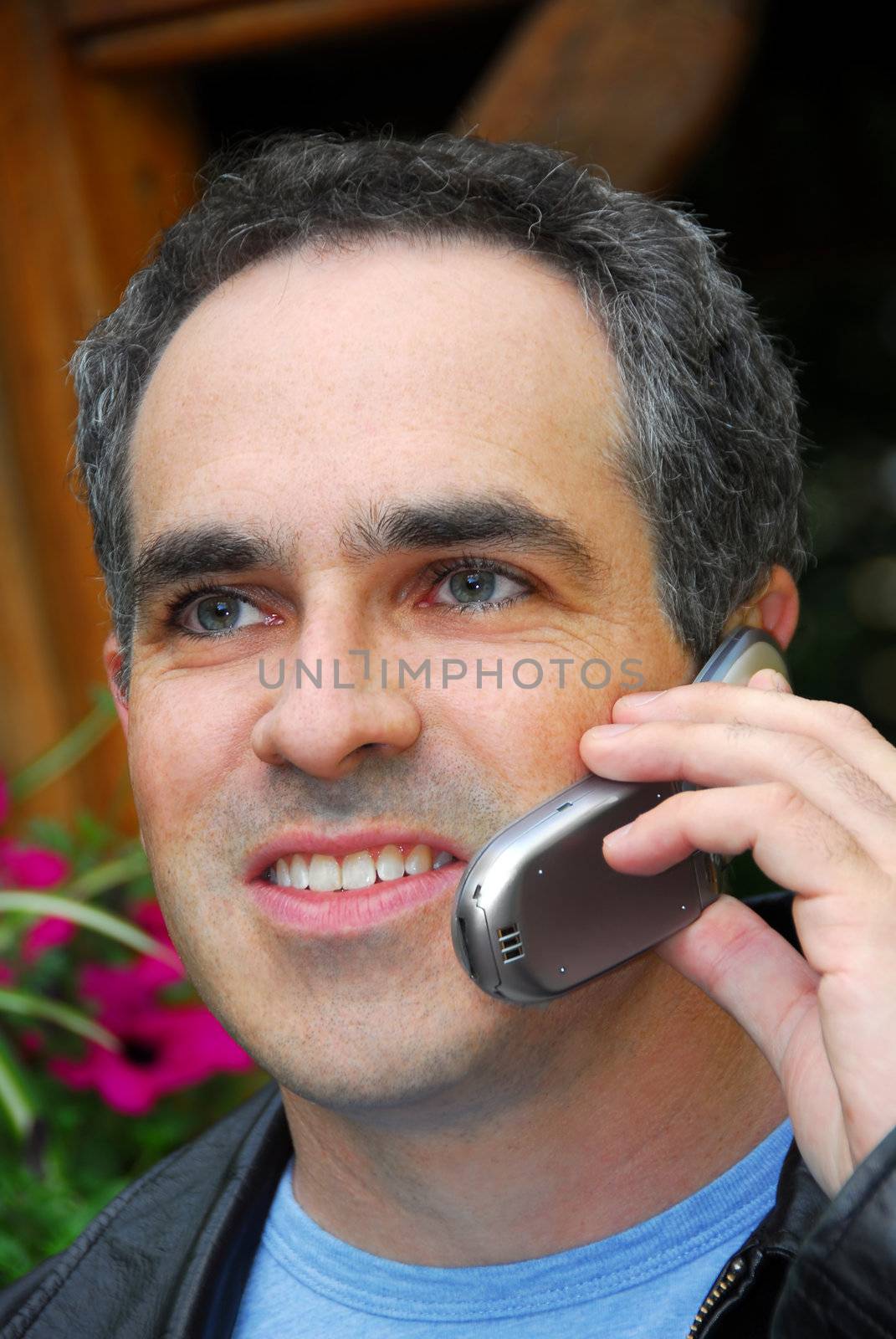 Attractive man talking on cell phone outside