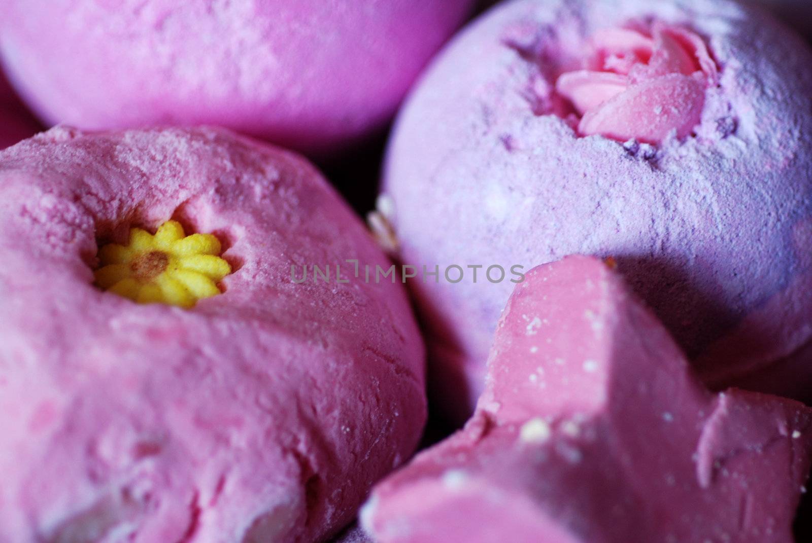 A close-up photograph of several bath bombs, bubble baths and soap, perfect for a girls' night in of pampering.