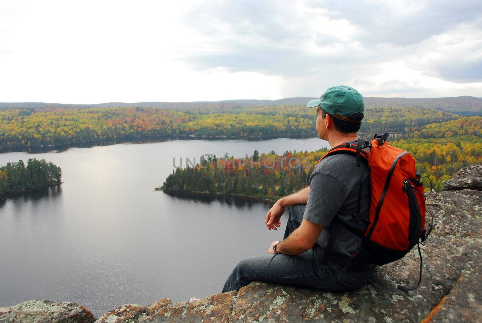 Man on top of a hill enjoying a scenic view