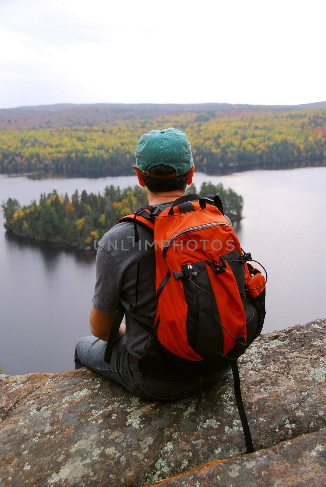 Man on top of a hill enjoying a scenic view