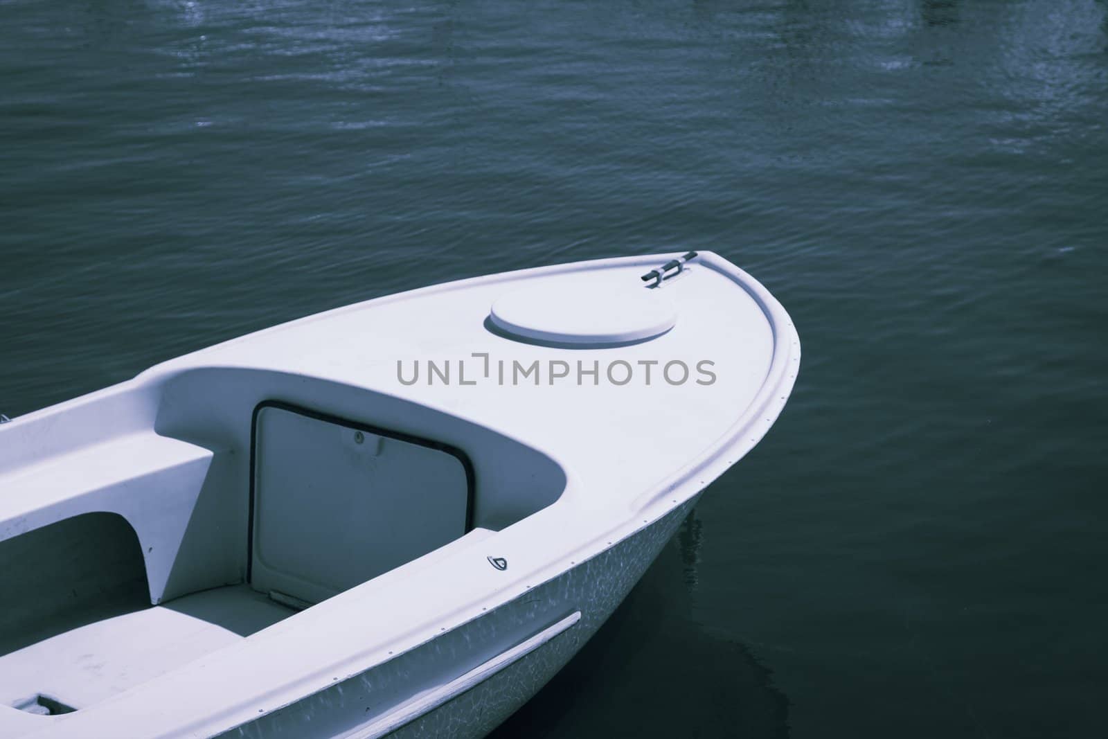 Old plastic small fishing boat in good condition by Lizard