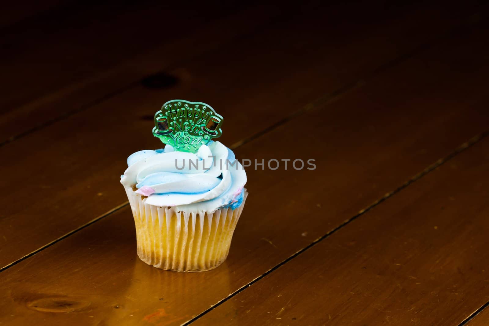 Close up of a cup cake on the wooden table