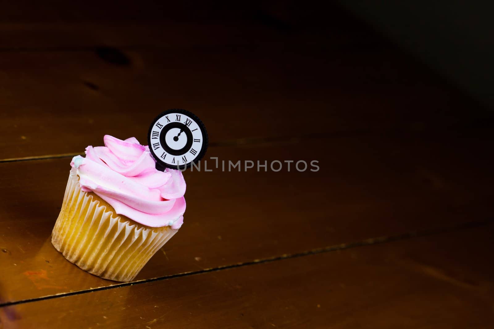 Close up of a cup cake on the wooden table