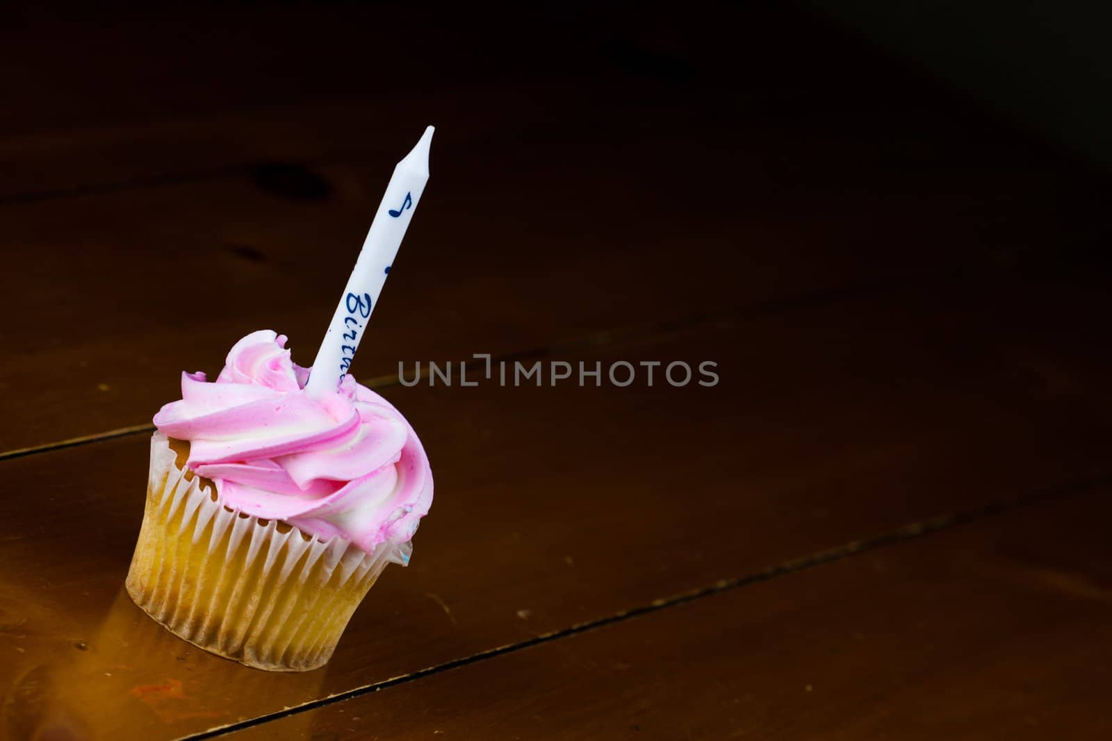 Close up of a cup cake on the wooden table