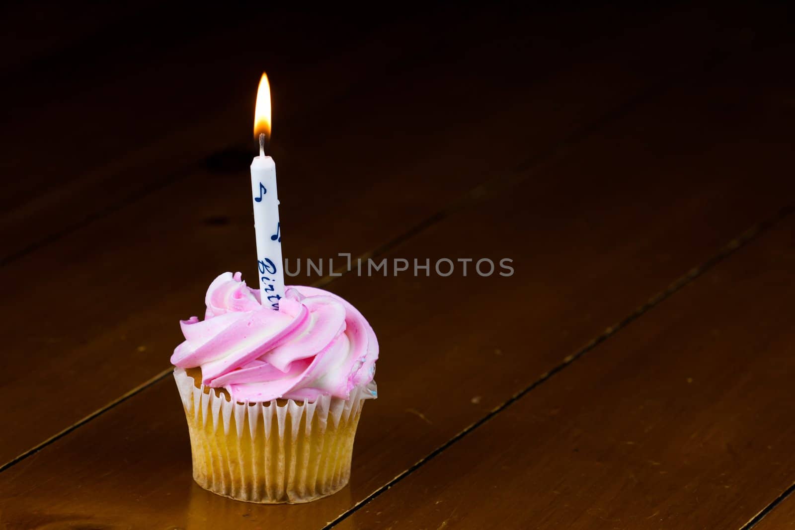 Close up of a cup cake on the wooden table