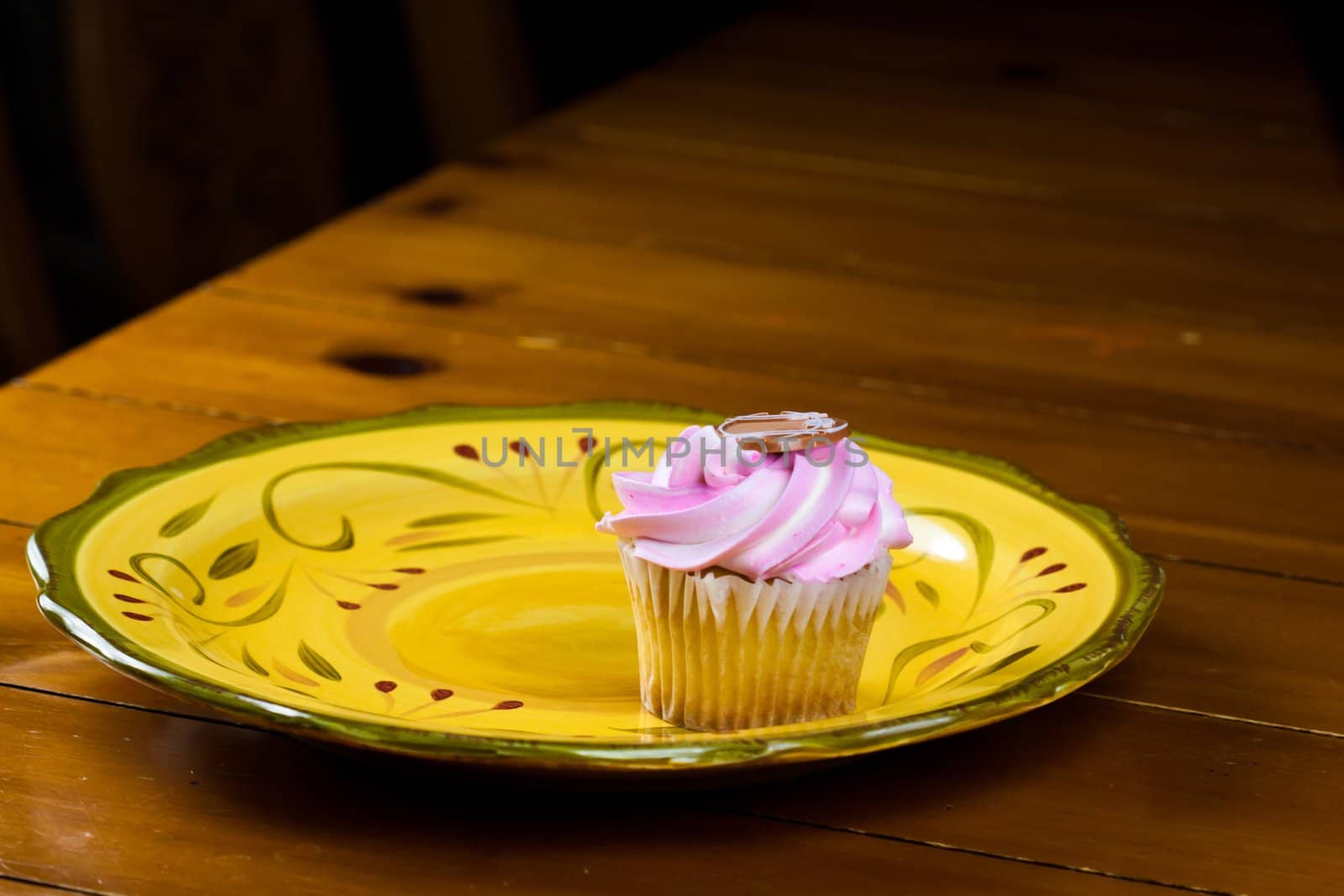 Close up of a cup cake on the wooden table