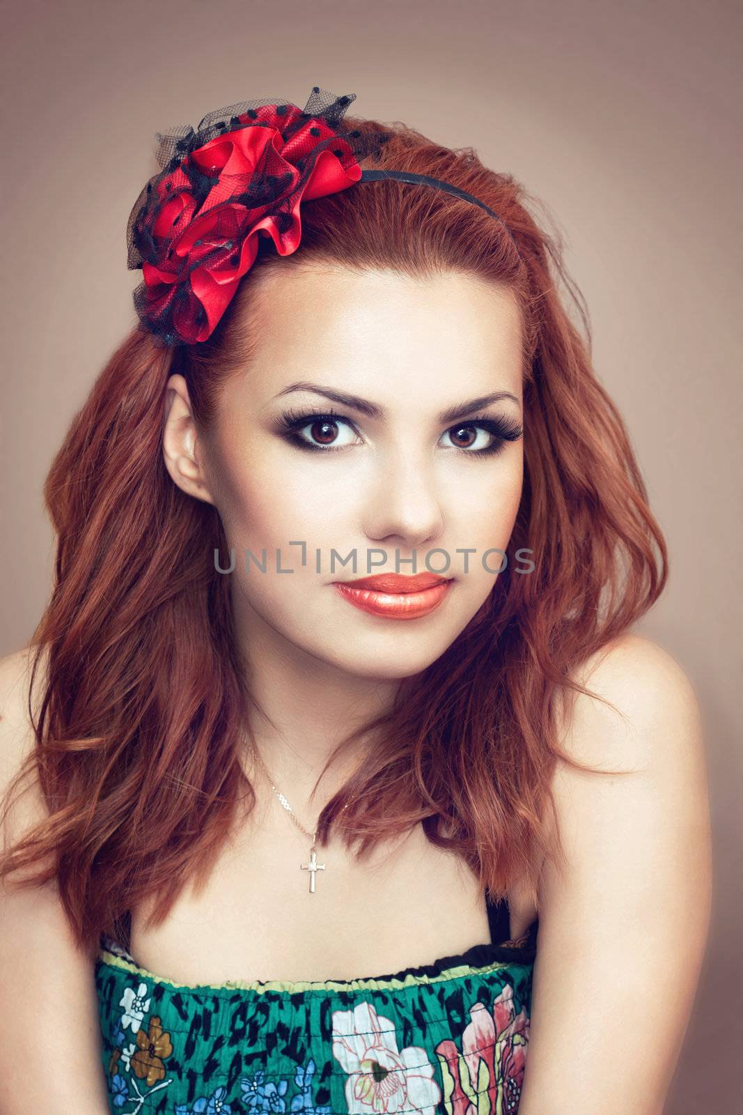 Portrait of a pretty red hair girl in the studio