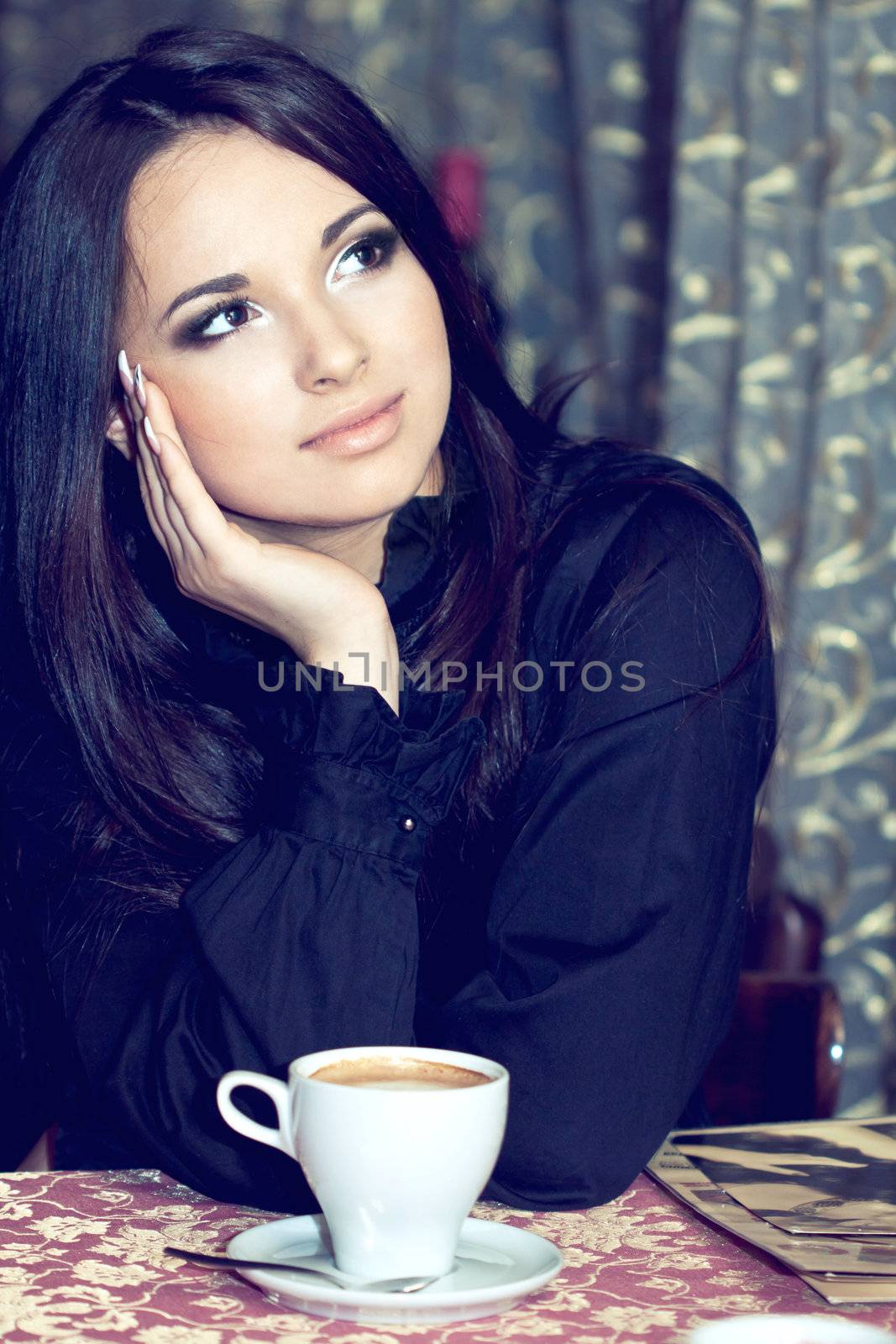 Pretty girl drinking coffee or tea and thinking