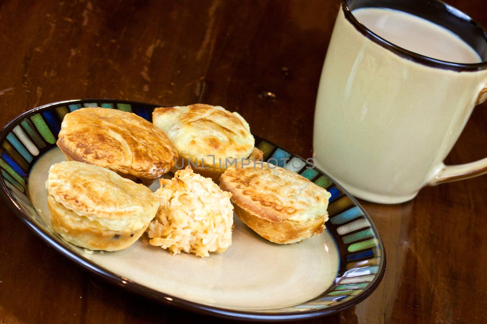 Mini cakes on a plate with a cup o coffee