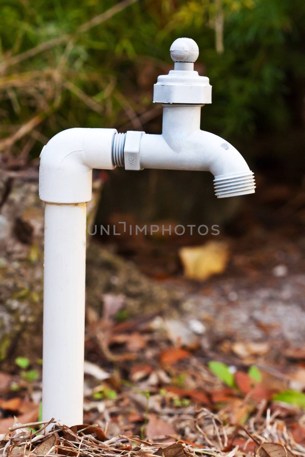 Close up of a white sink outdoors on the ground