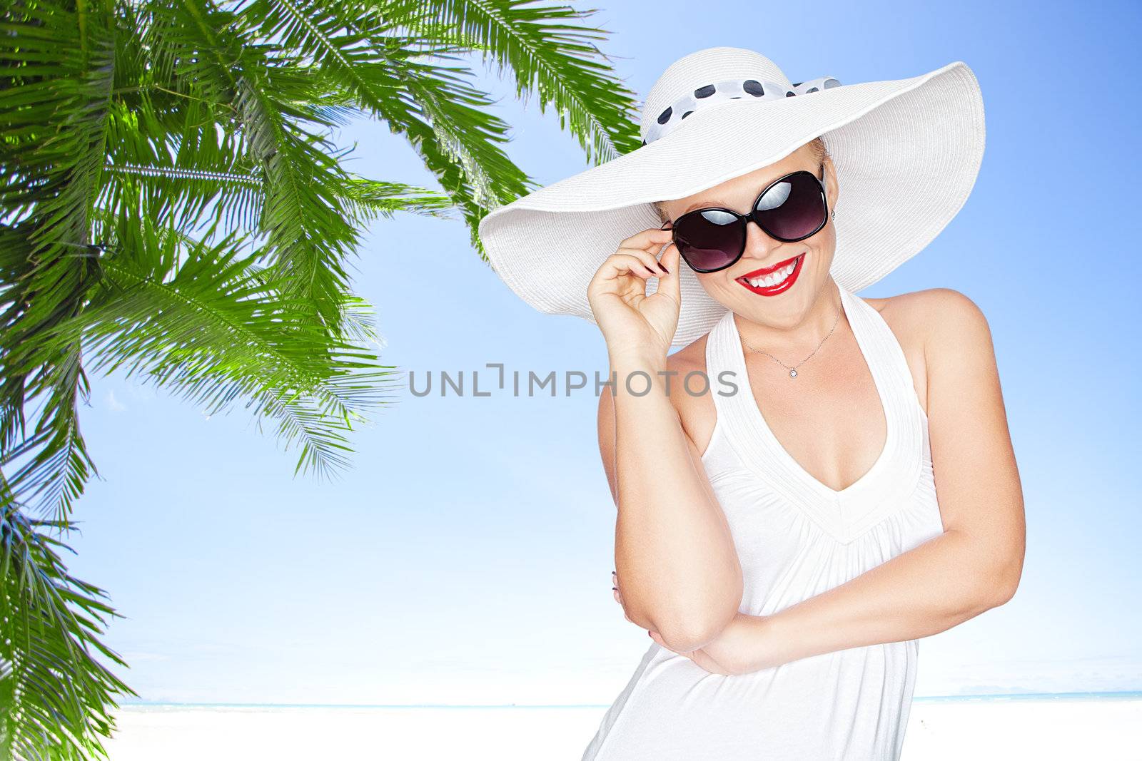 portrait of young beautiful woman in hat and sunglasses