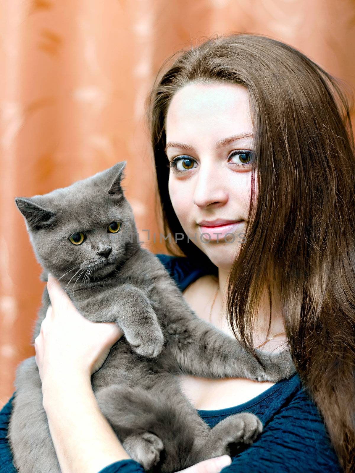 portrait of a beautiful young girl with a cat on hands