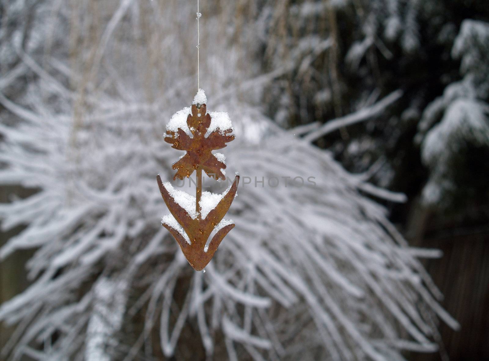 Snow Covered Tree Branches and Rusty Flower Windchime