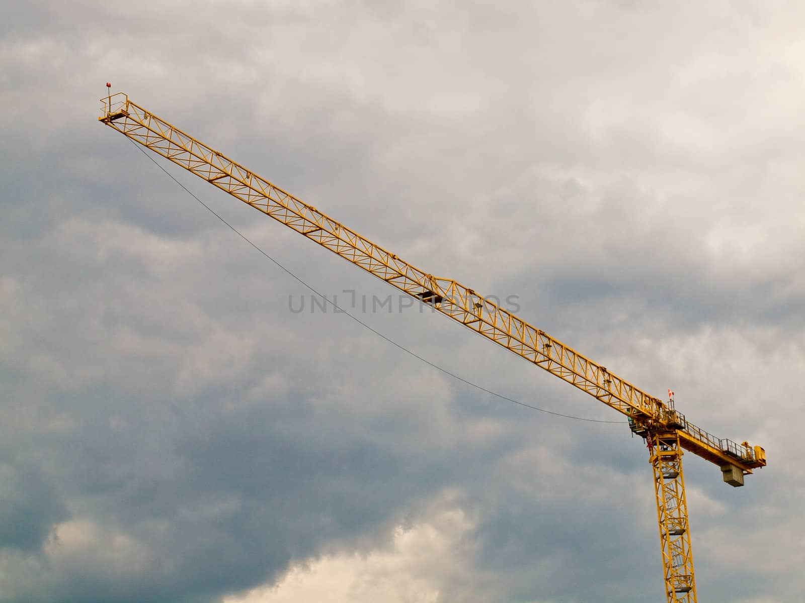 Large Construction Crane in Front of a Cloudy Sky