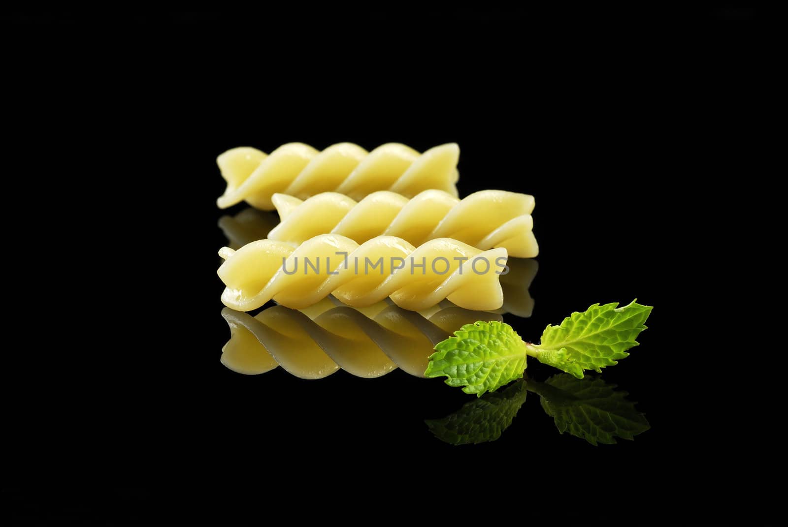 Fusilli pasta isolated on black background