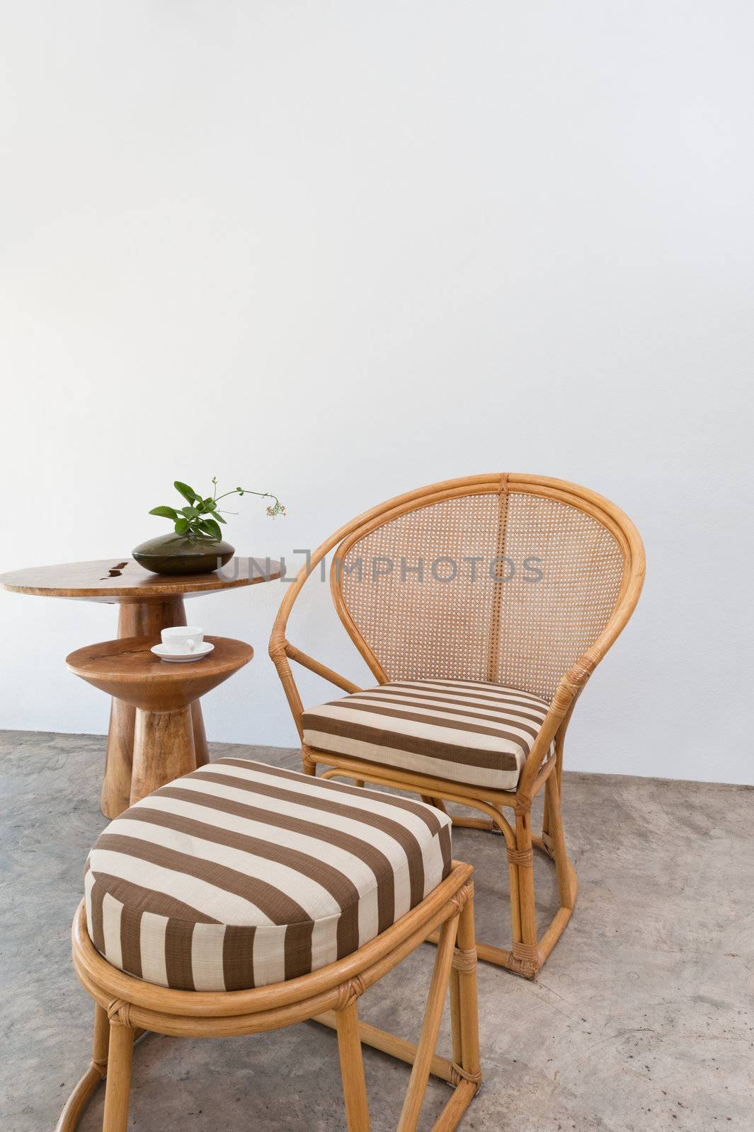 Beautiful beige bamboo rattan furniture in front of a white wall