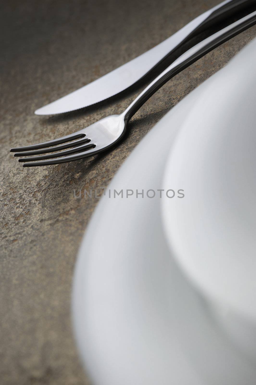 Close-up of silverware , on the dining table. by stokkete