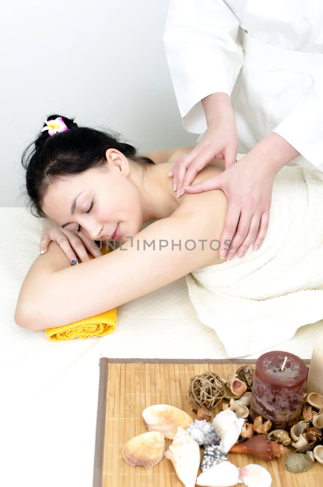 Young lady receiving back massage at spa center