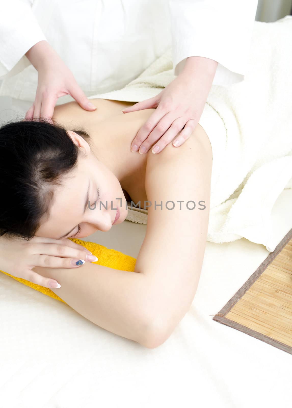 Young lady receiving back massage at spa center