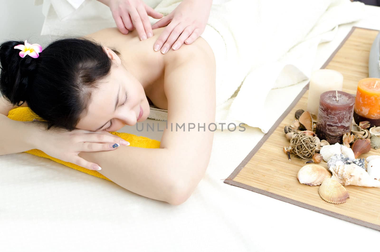 Young lady receiving back massage at spa center