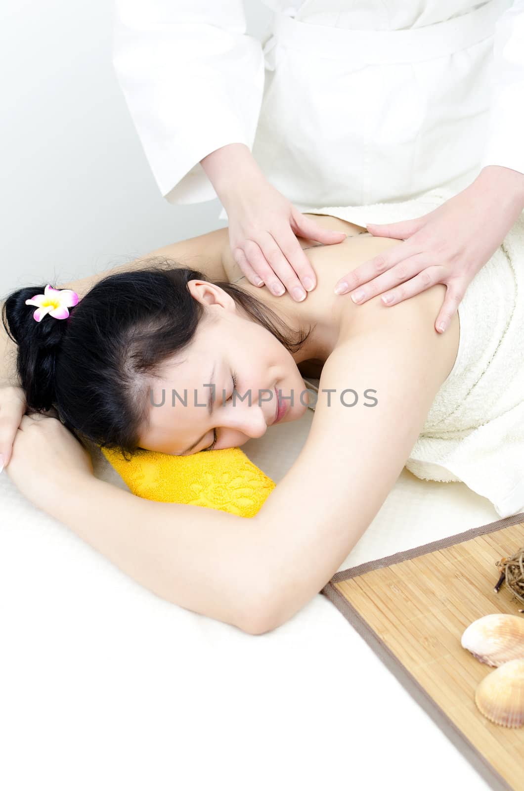 Young lady receiving back massage at spa center