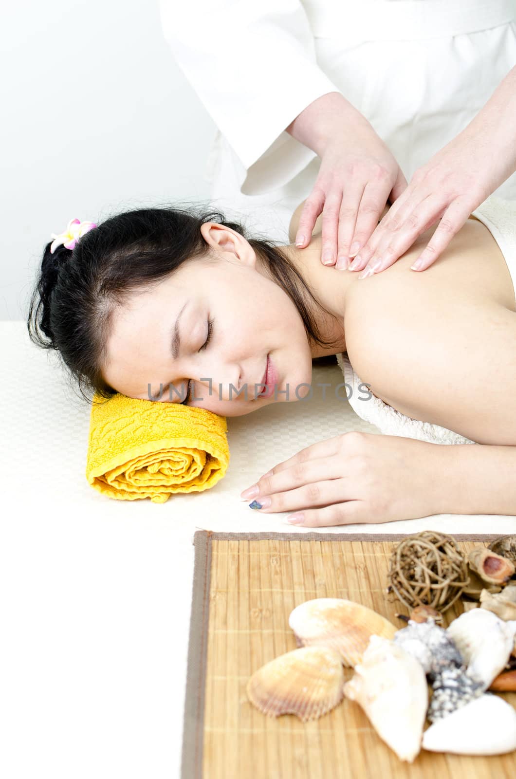 Young lady receiving back massage at spa center