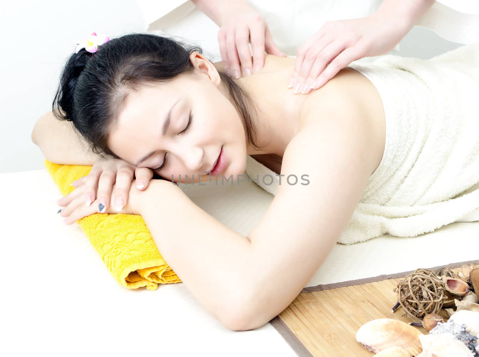 Young lady receiving back massage at spa center