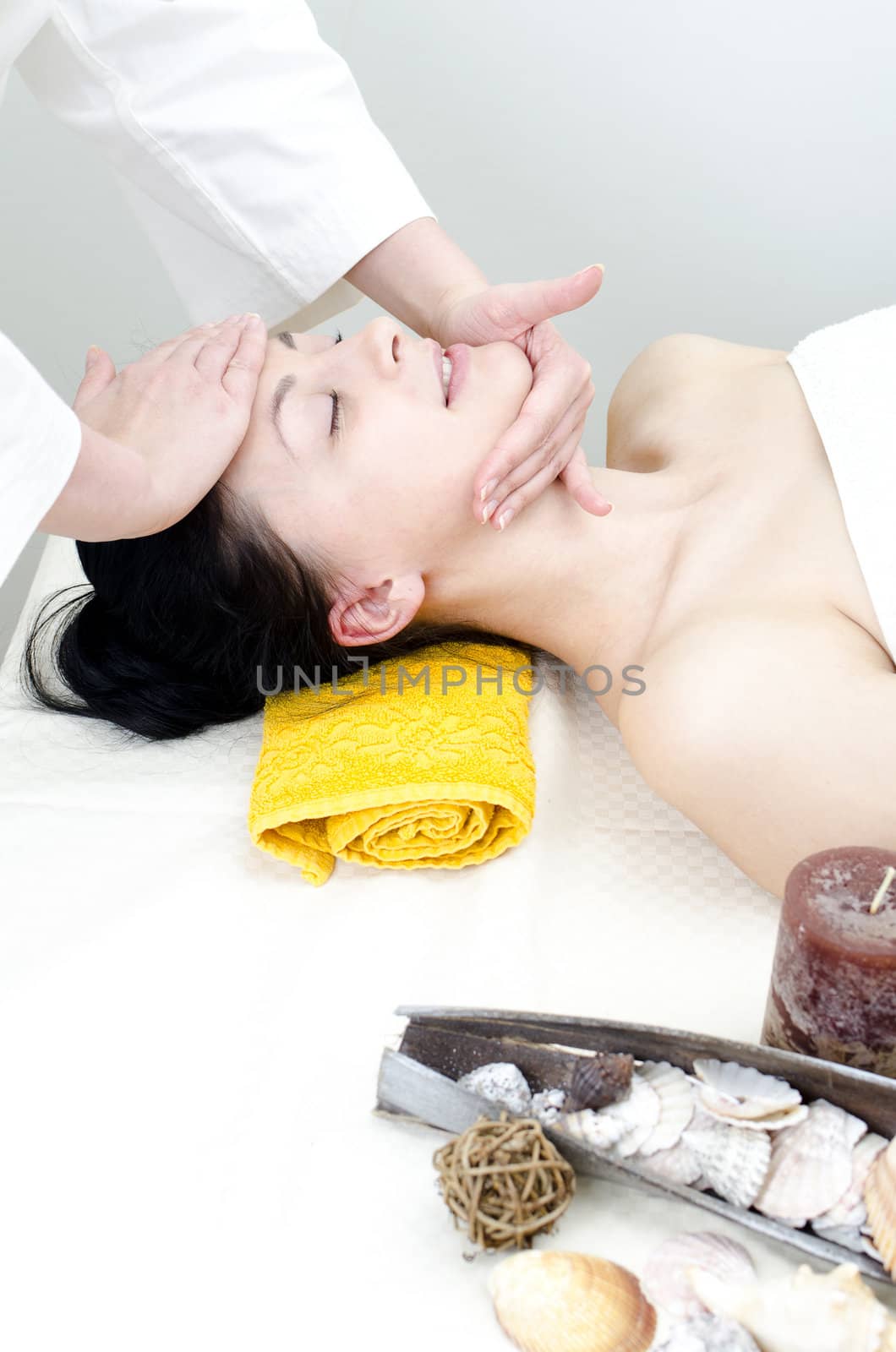 Young lady receiving face massage at spa center