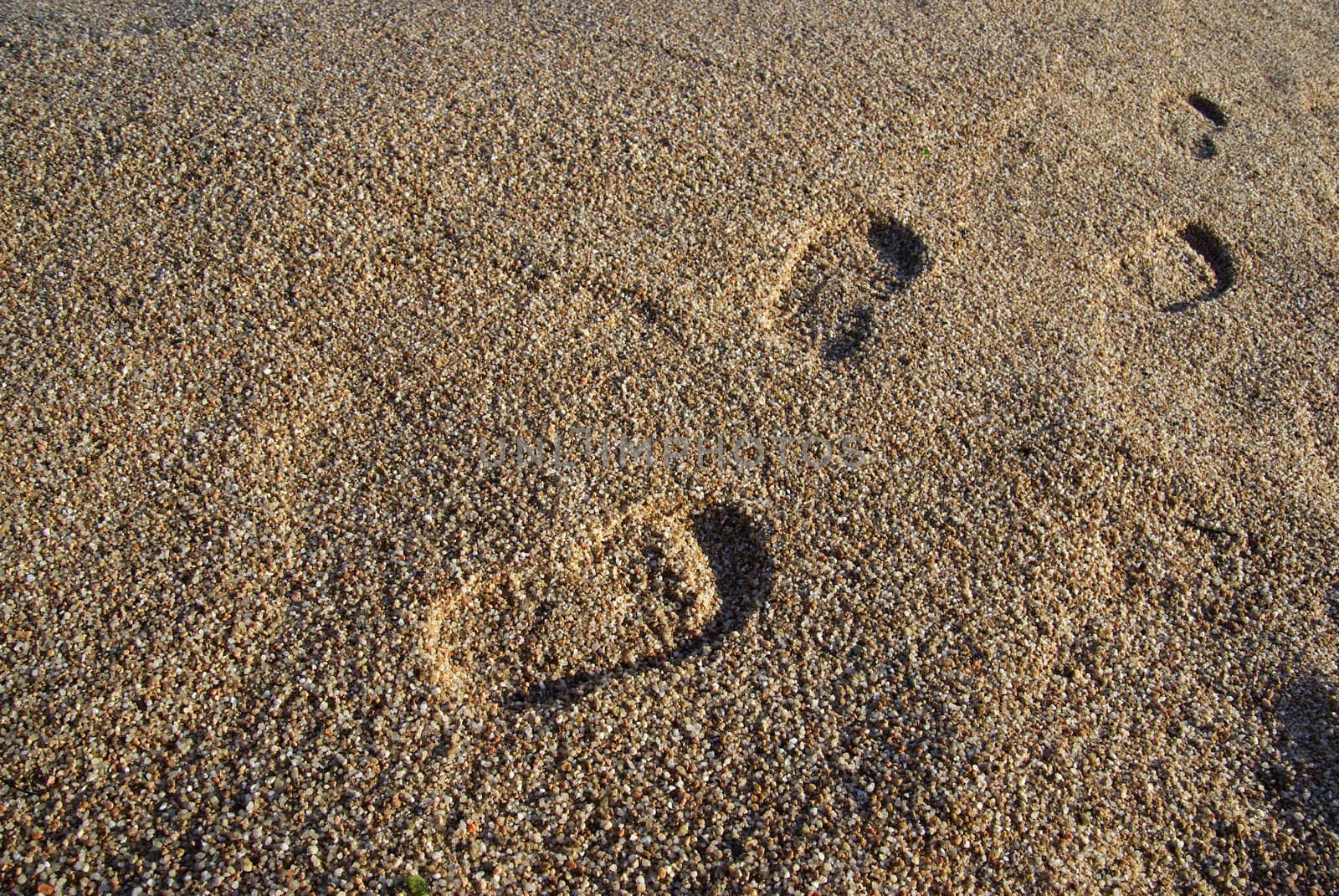 Foot prints on the mediterranean beach. Sunset time. As backdrop or background.