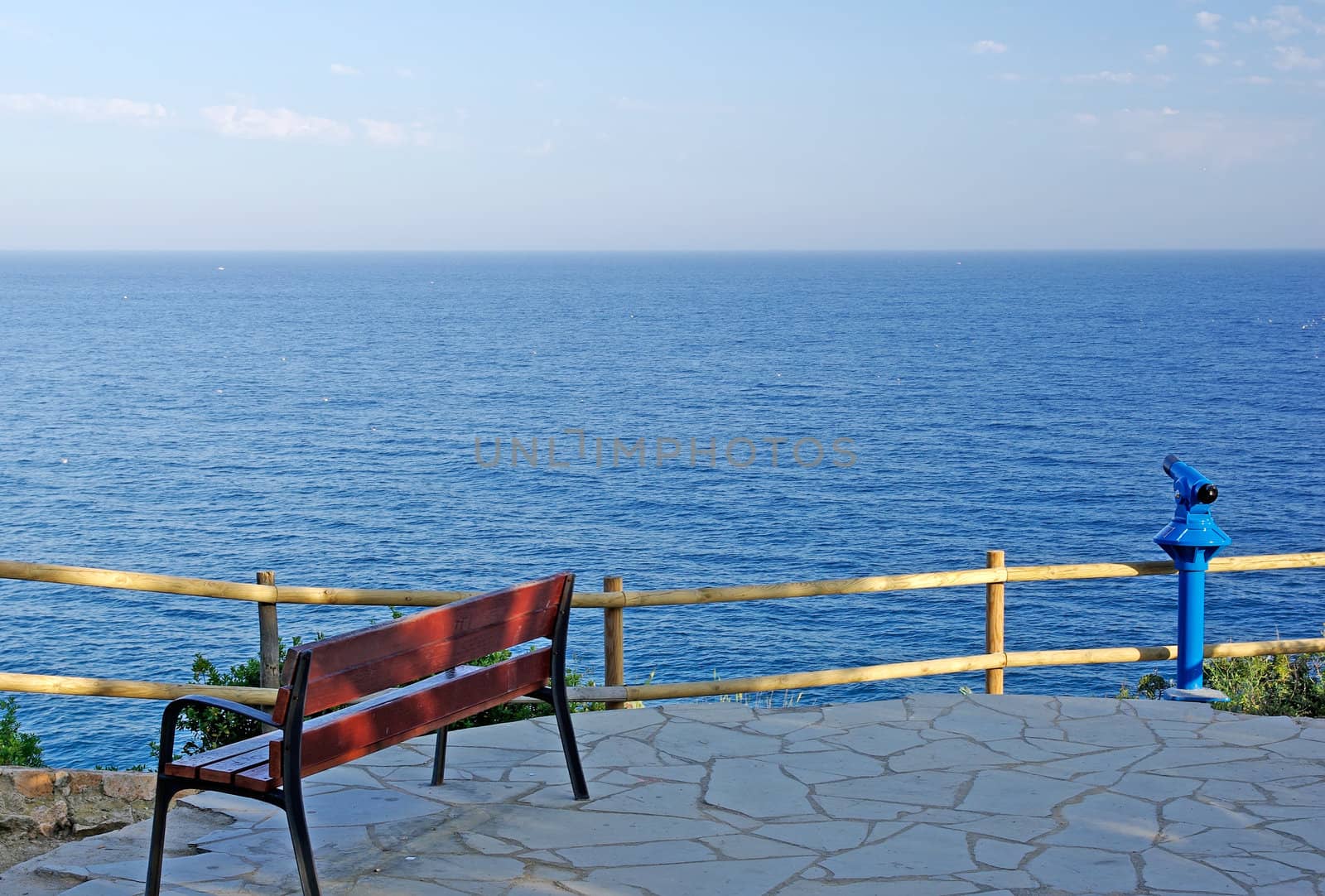 Empty bench on the seashore of Mediterranean sea.