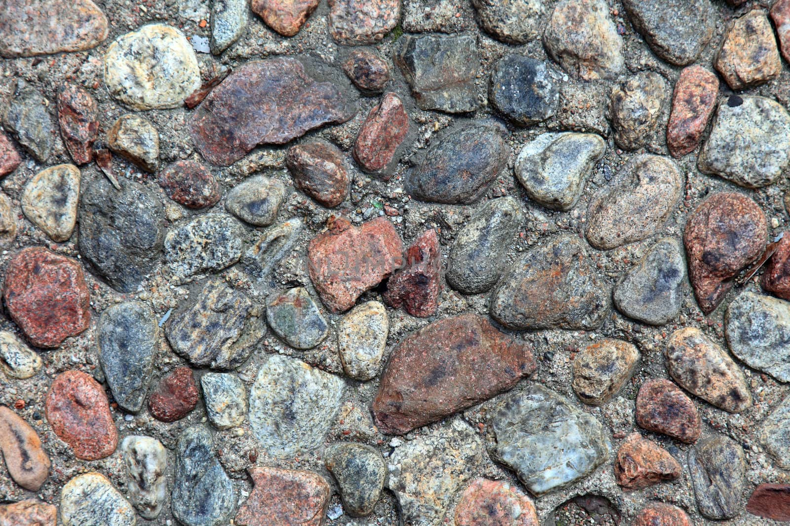 Textured pebble sidewalk background. by borodaev